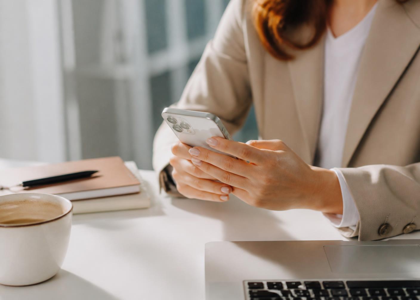 Real estate agent reviewing messages at a desk